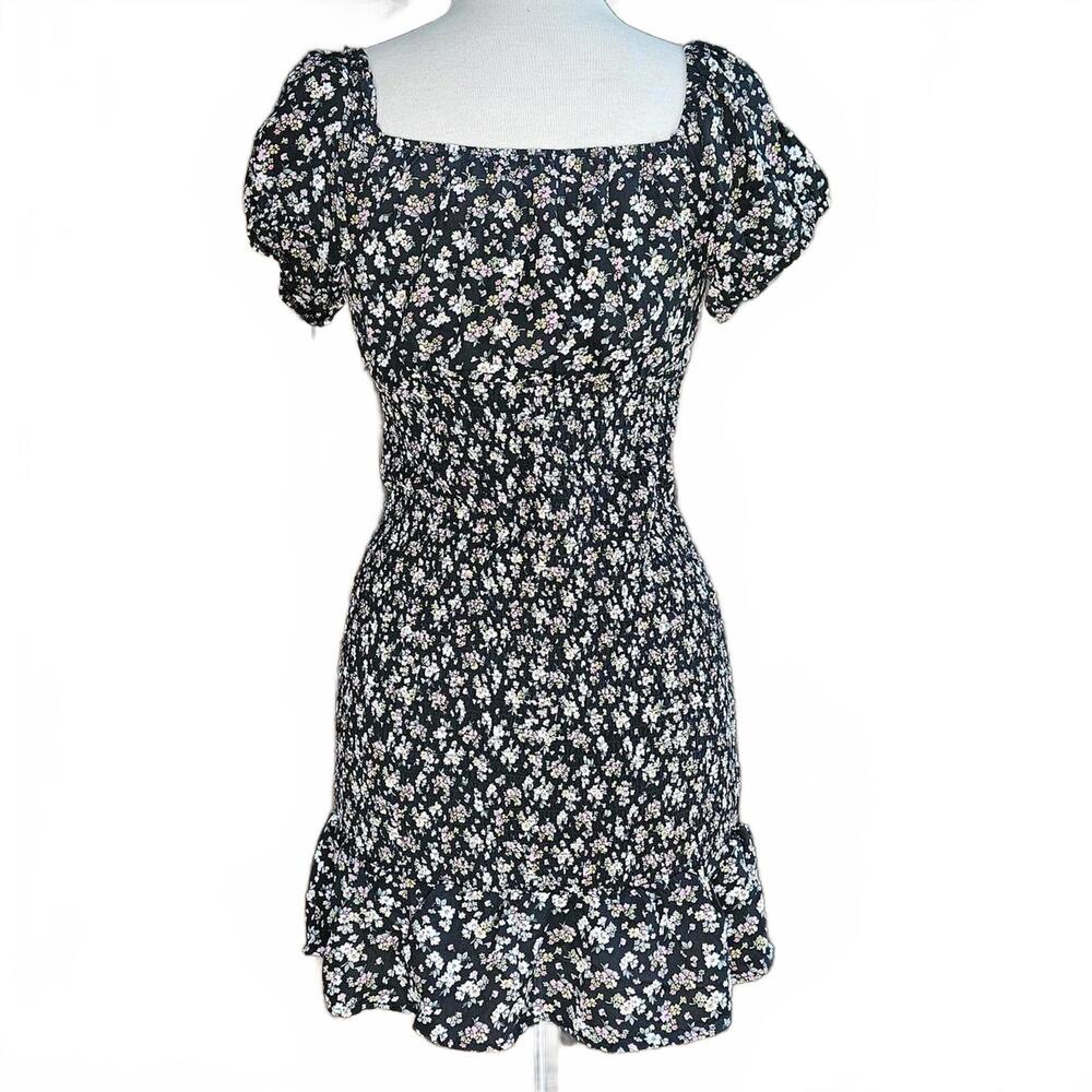 Black floral ruffle milkmaid style mini dress, puff sleeves.